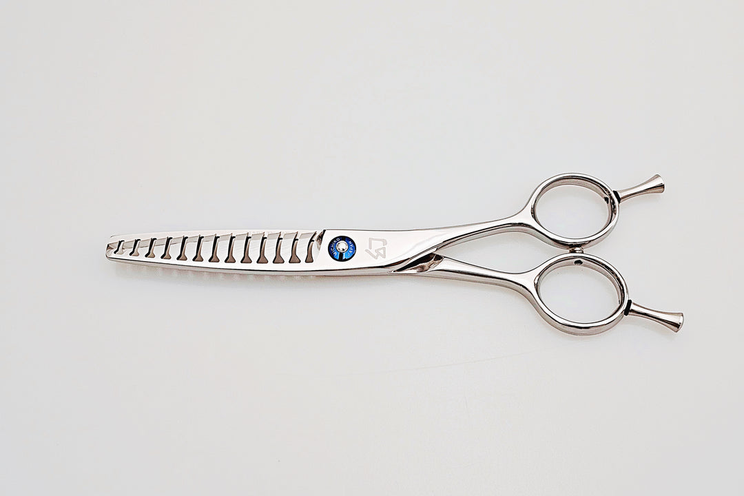 Stainless steel hair cutting shears on a light gray background