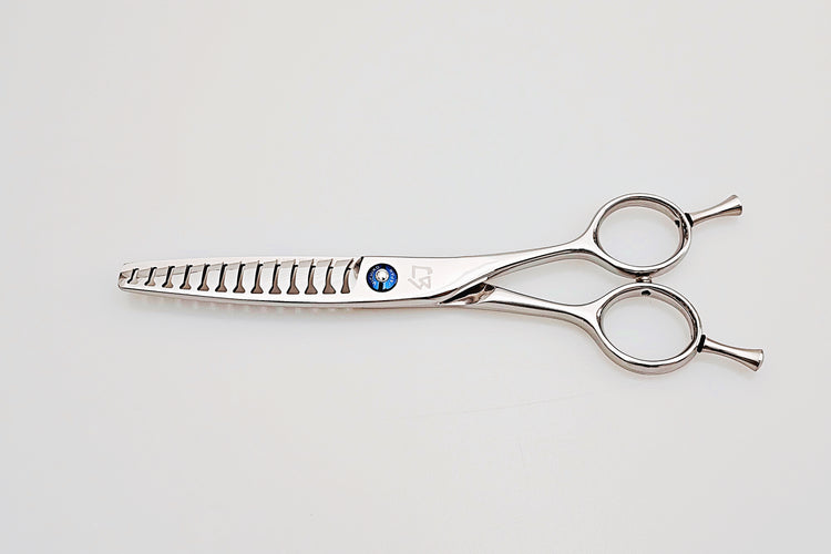 Stainless steel hair cutting shears on a light gray background