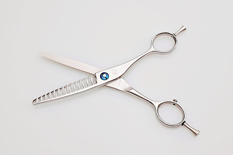 Pair of texturizing scissors on a white background