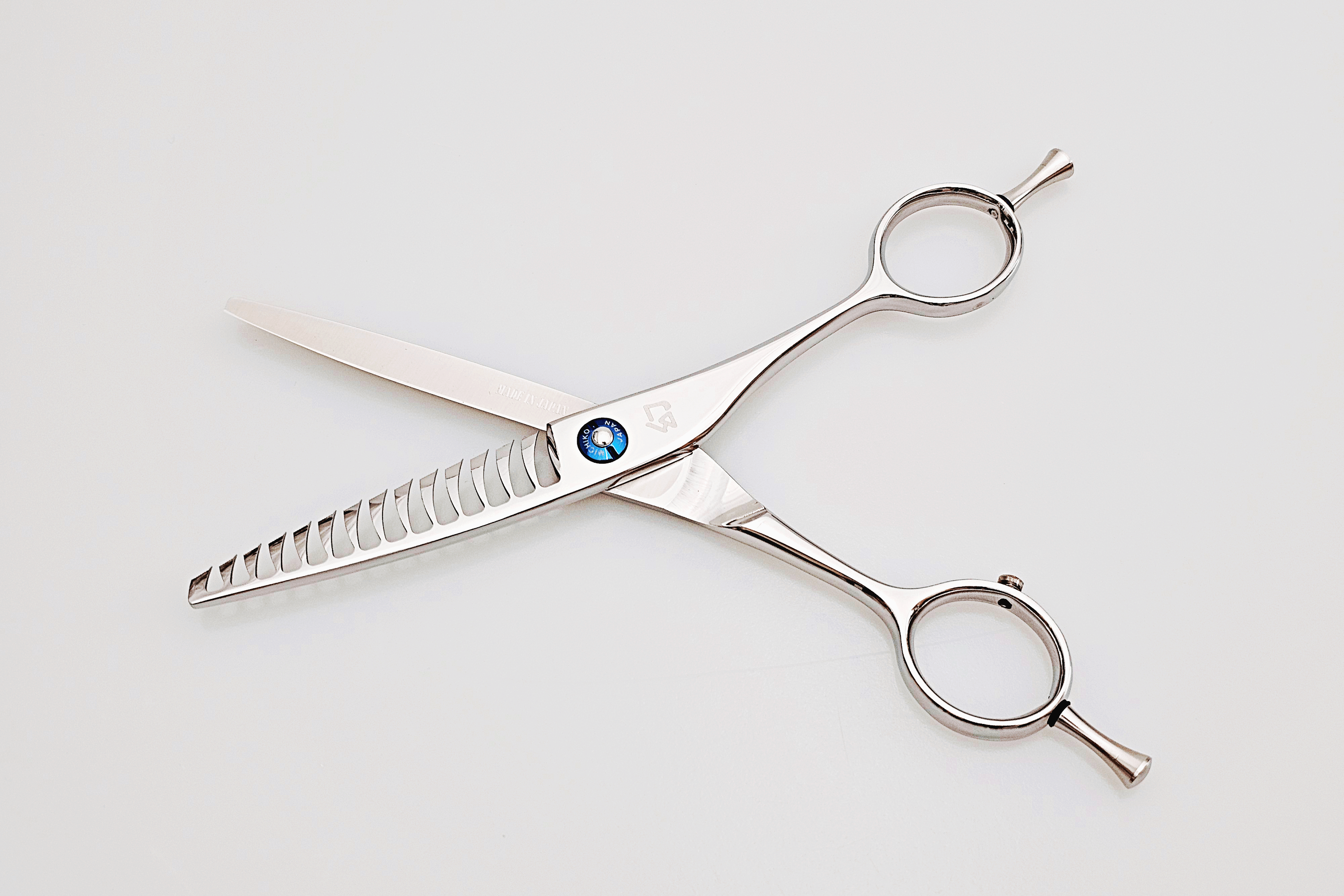 Pair of texturizing scissors on a white background