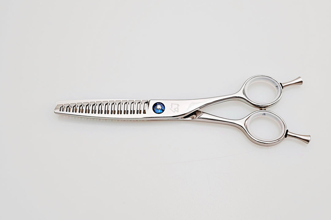Hair scissors with a brand logo on a light gray background