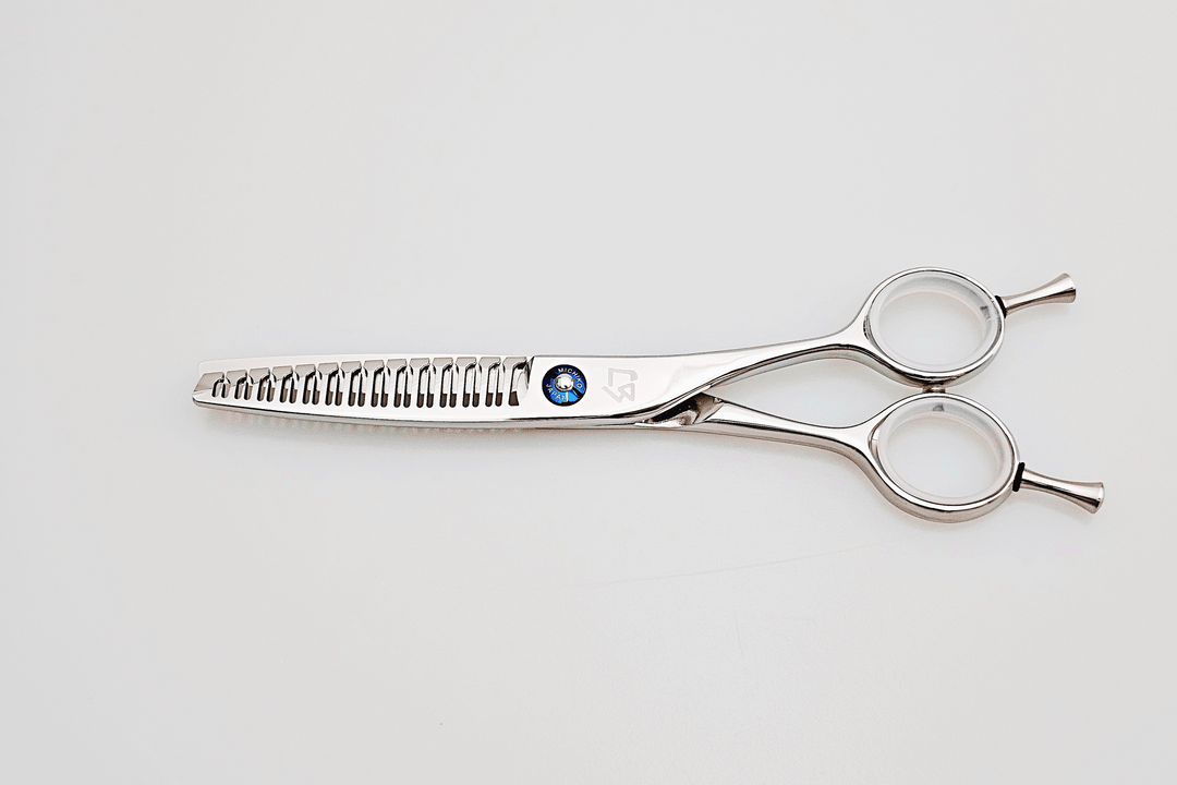 Hair scissors with a brand logo on a light gray background