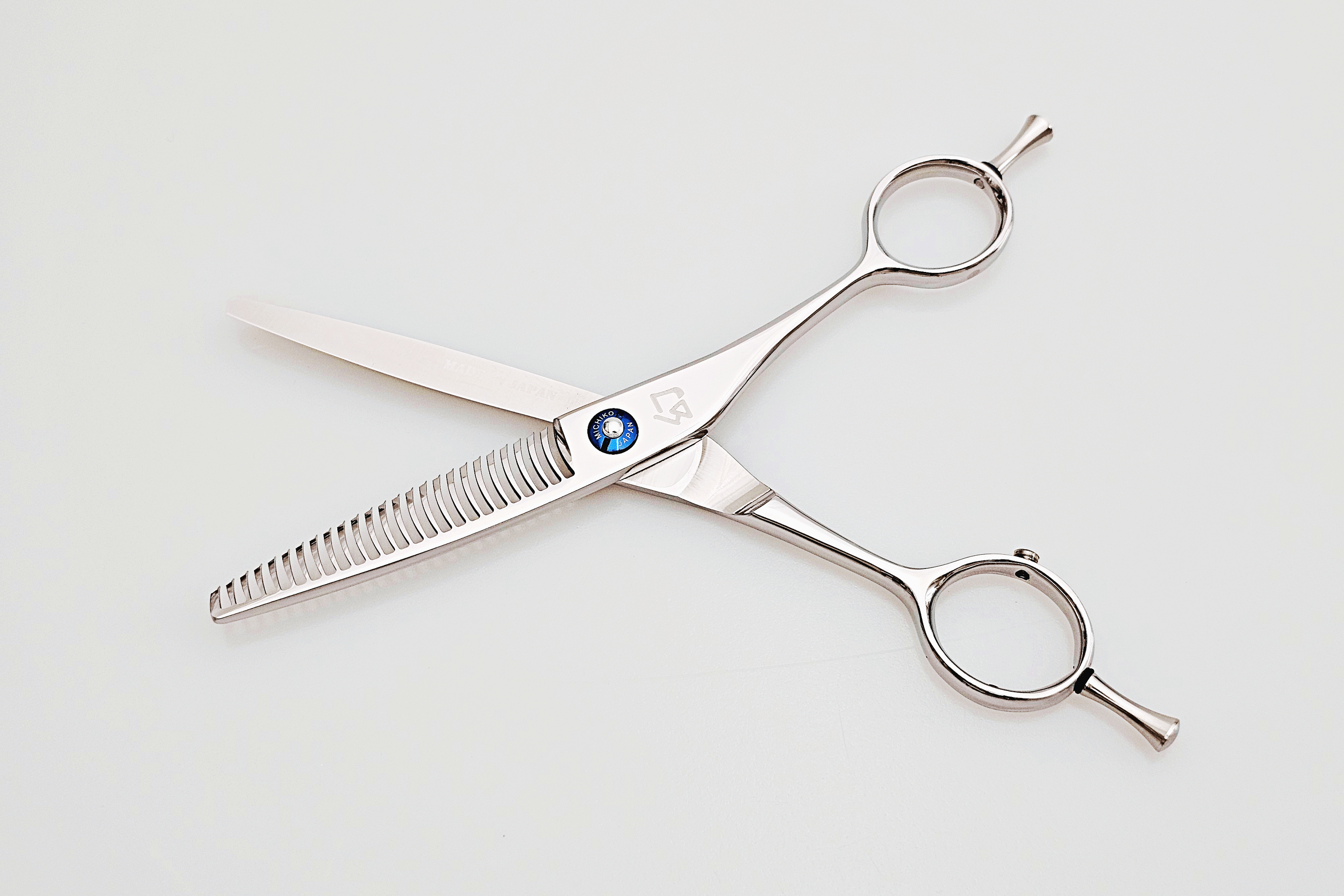 Hair scissors with a blue logo on a white background