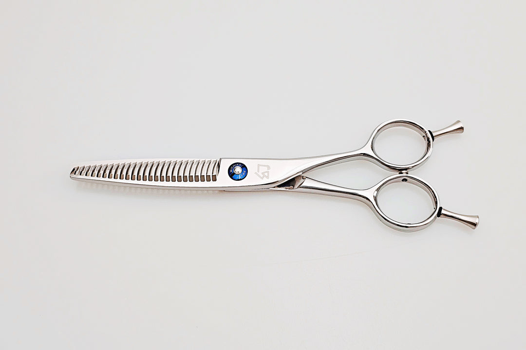 Hair cutting scissors on a light gray background