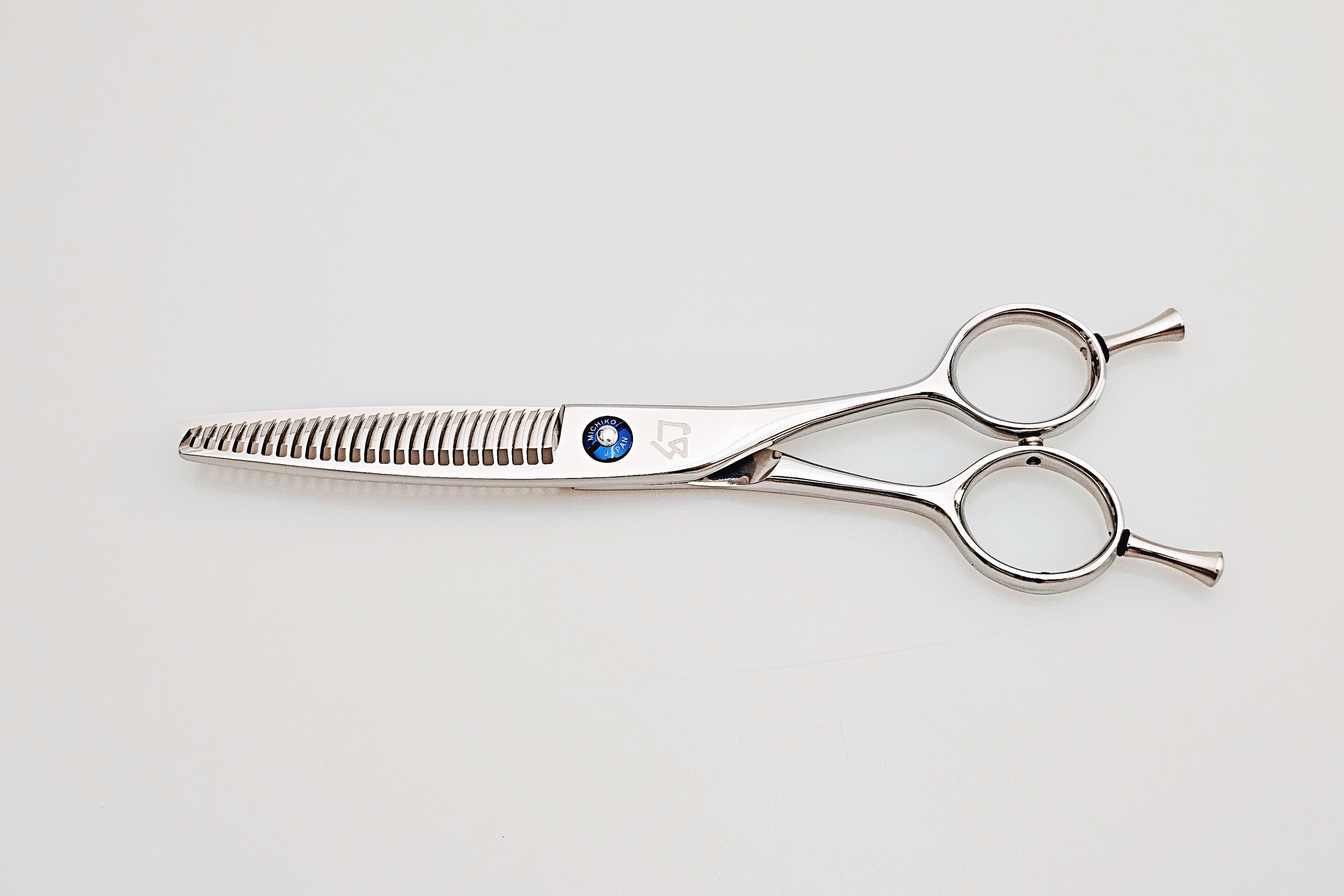 Hair cutting scissors on a light gray background