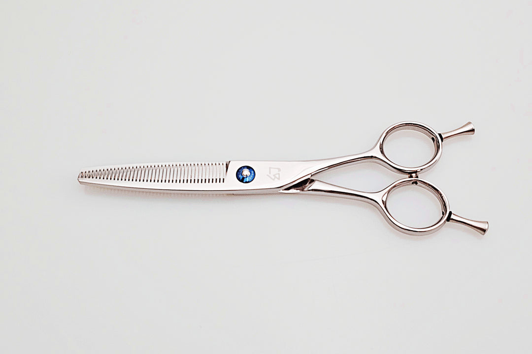 Hair cutting scissors on a light gray background