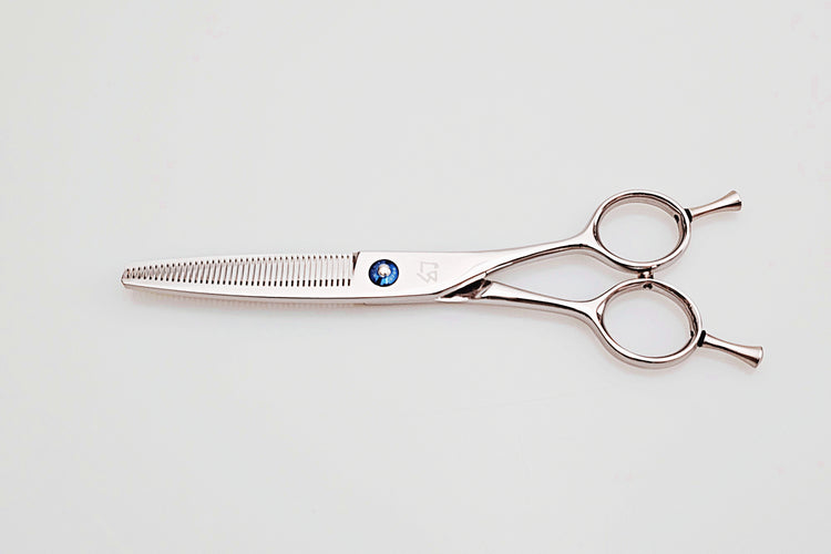 Hair cutting scissors on a light gray background