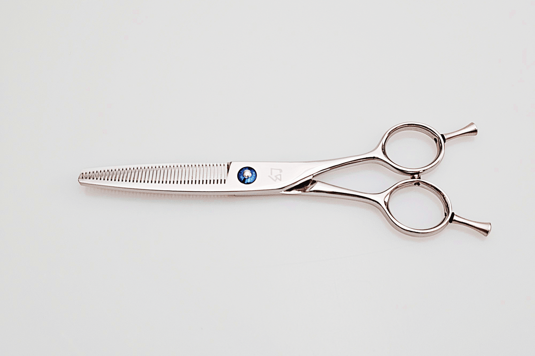 Hair cutting scissors on a light gray background