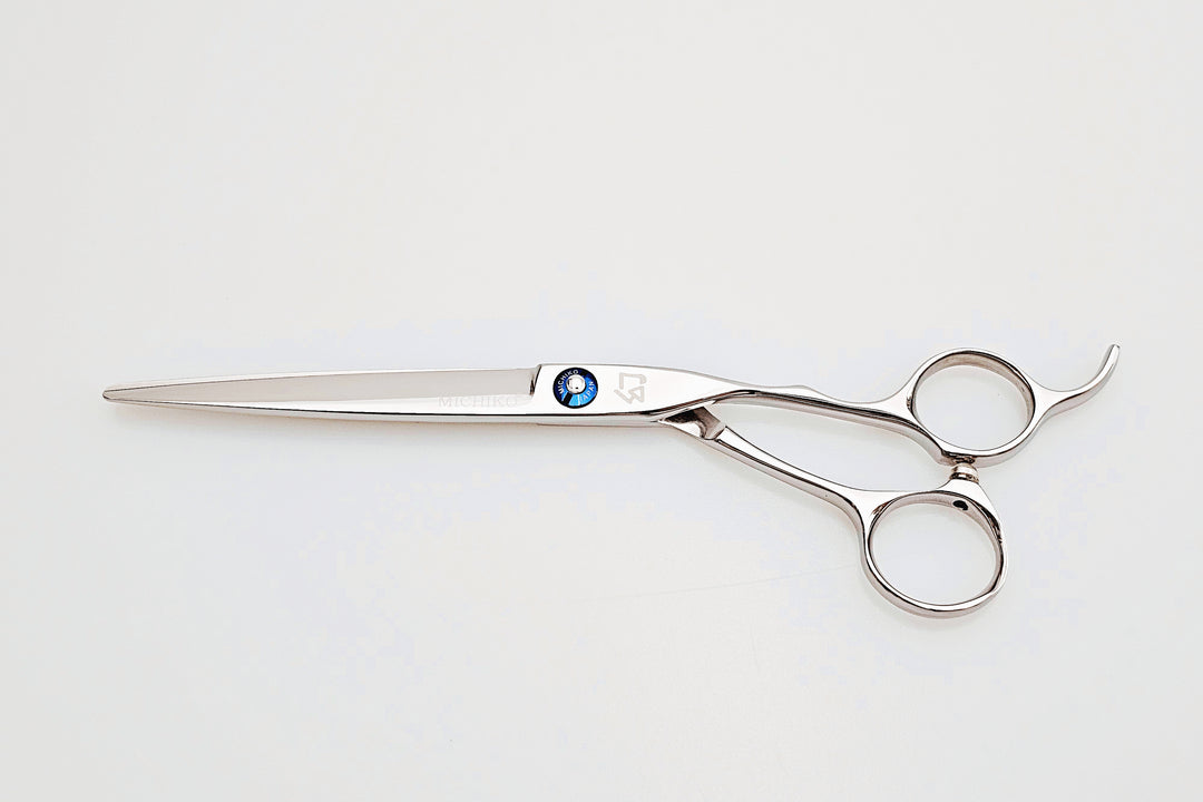Stainless steel hair cutting shears on a white background
