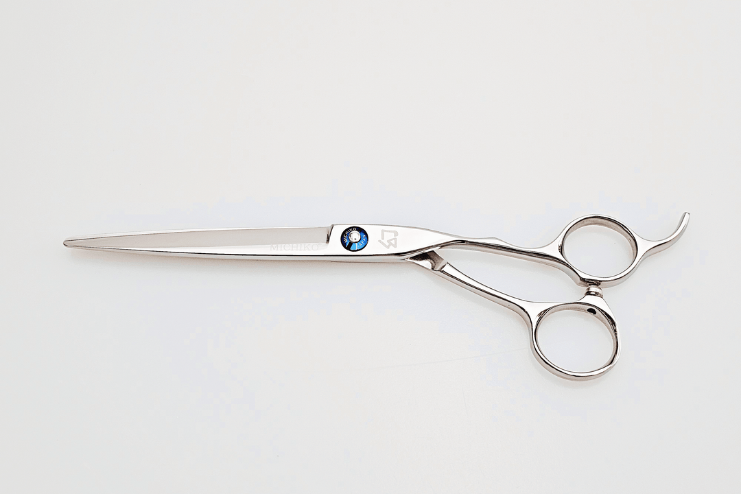Stainless steel hair cutting shears on a white background