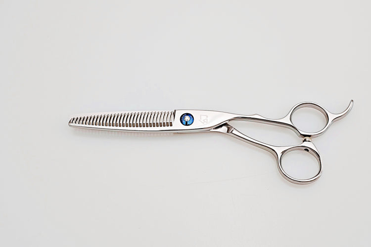 Pair of thinning scissors on a light gray background