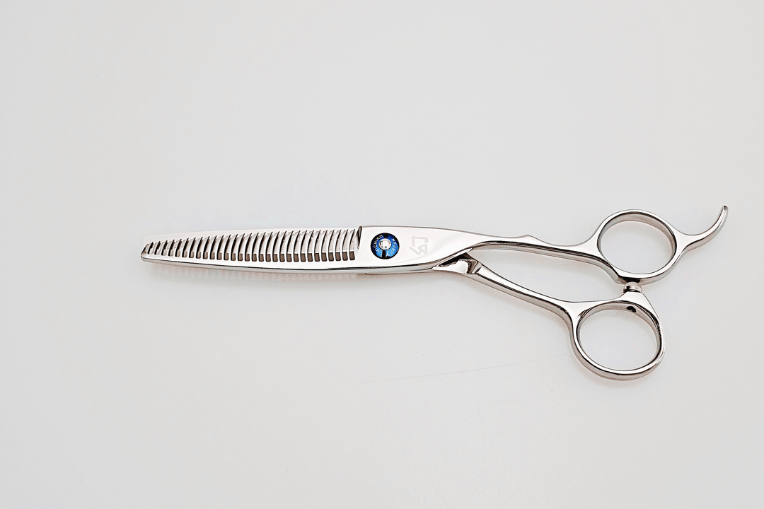 Pair of thinning scissors on a light gray background