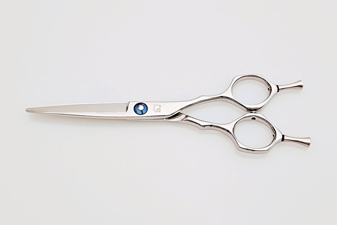 Hair scissors with a blue screw on a white background