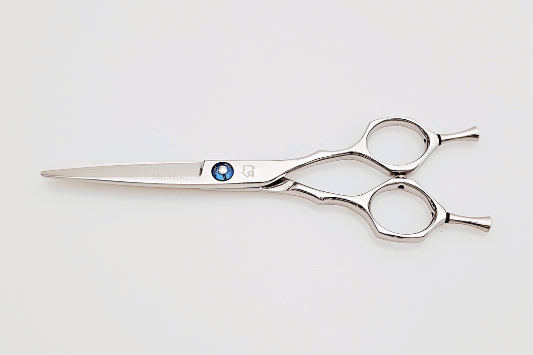 Hair scissors with a blue screw on a white background