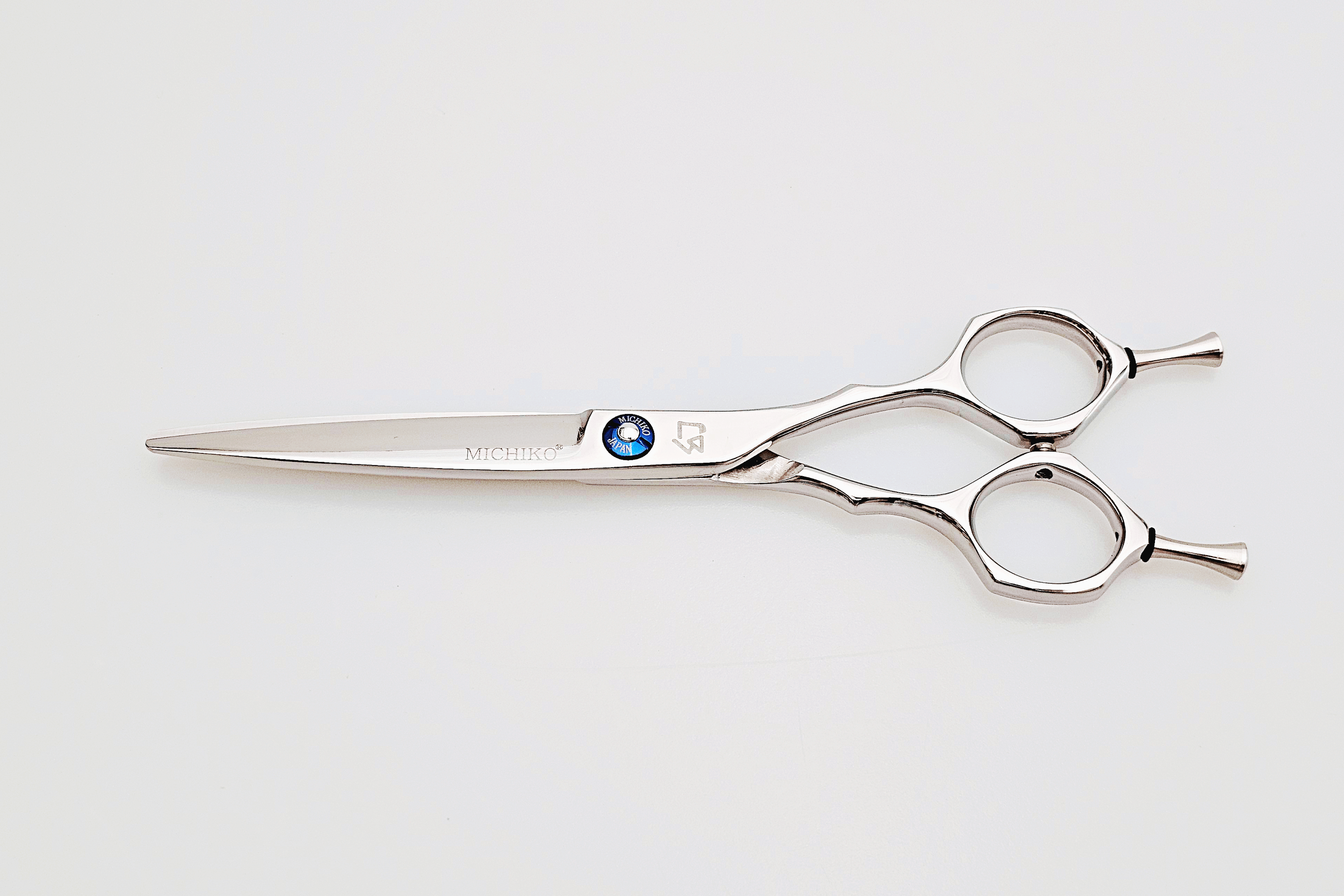 Hair scissors with a brand logo on a white background