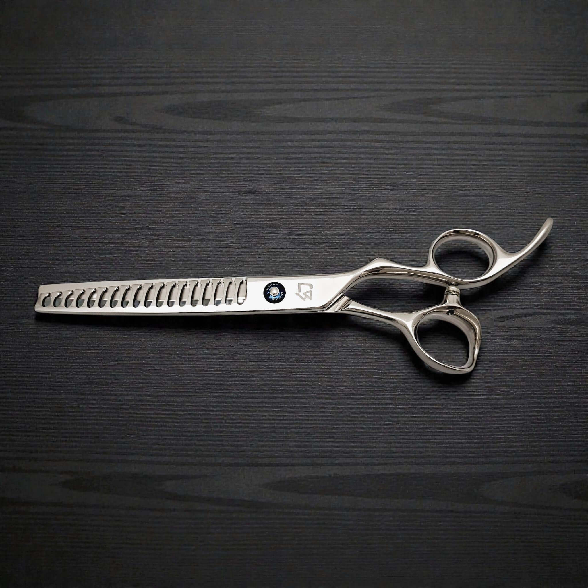 Japanese 7-inch hair-cutting scissors on a dark wooden surface.