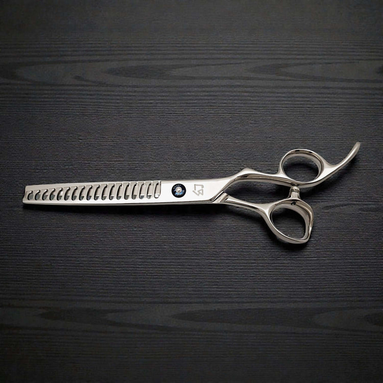 Japanese 7-inch hair-cutting scissors on a dark wooden surface.
