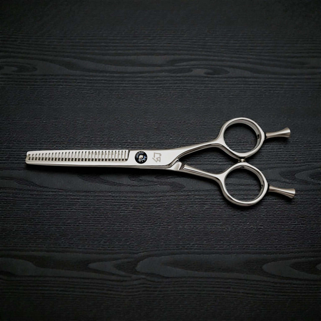 Hair thinning scissors on a dark wooden surface