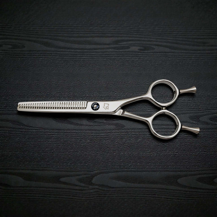 Hair thinning scissors on a dark wooden surface