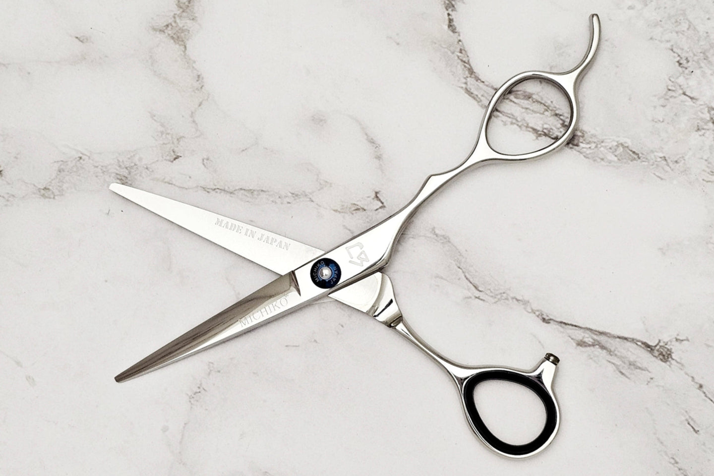 Hair cutting shears on a marble surface