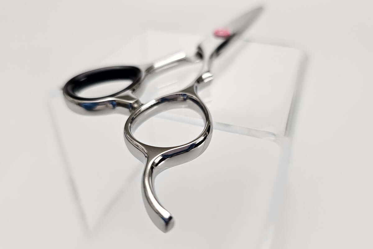 Close up of hair scissors' handle on a white background
