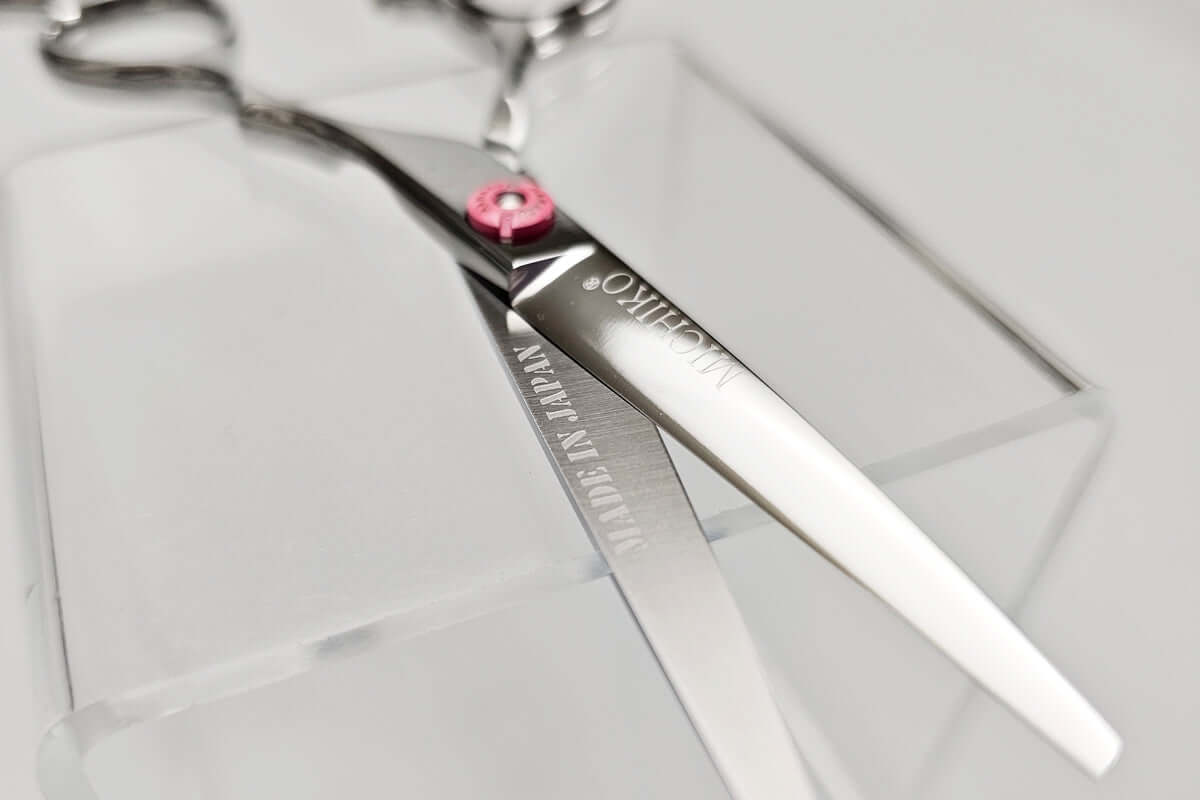 Hair cutting scissors with MICHIKO brand name on a clear background