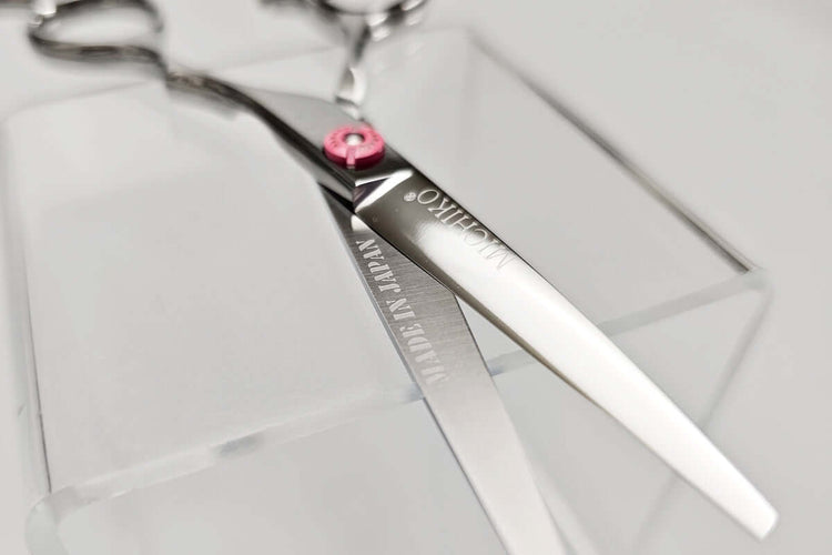 Hair cutting scissors with MICHIKO brand name on a clear background