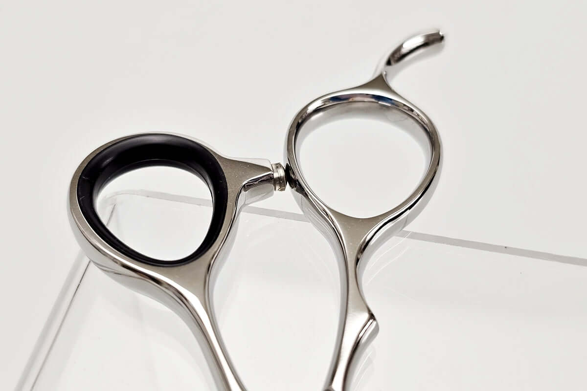Hair cutting shears' handle on a white background