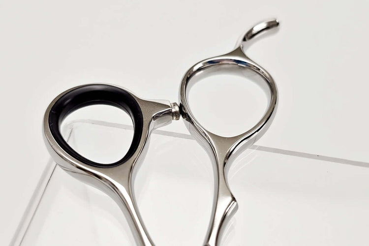Hair cutting shears' handle on a white background