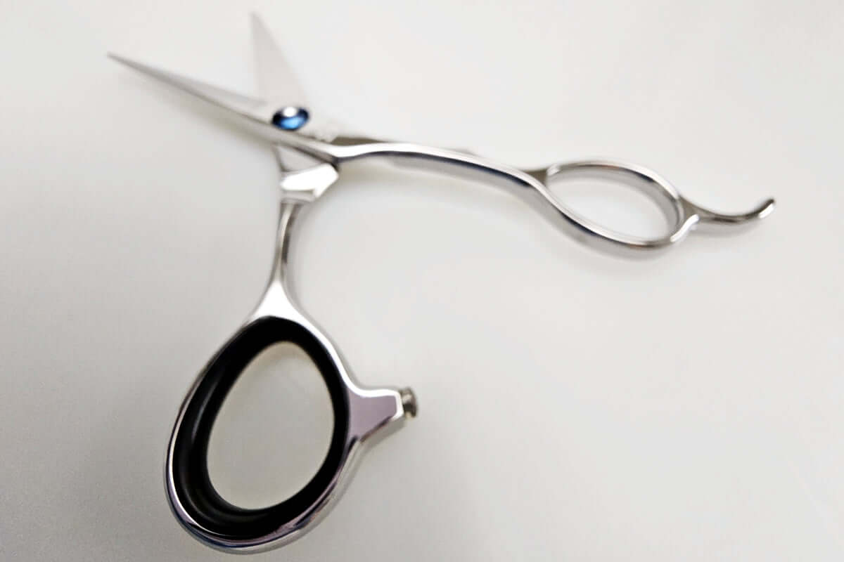 Hair cutting scissors on a light gray background