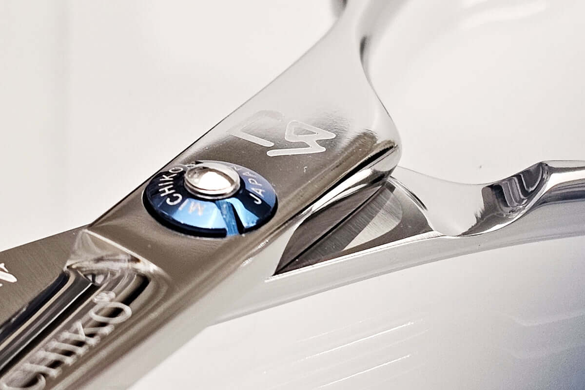 Close-up of a MICHIKO hair cutting shear on a white background