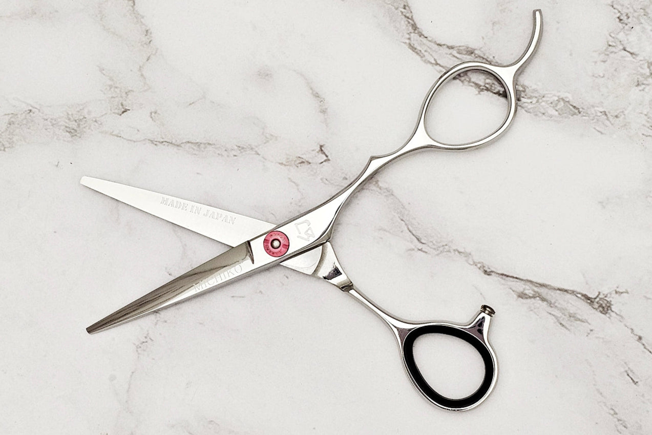Hair cutting shears on a marble surface