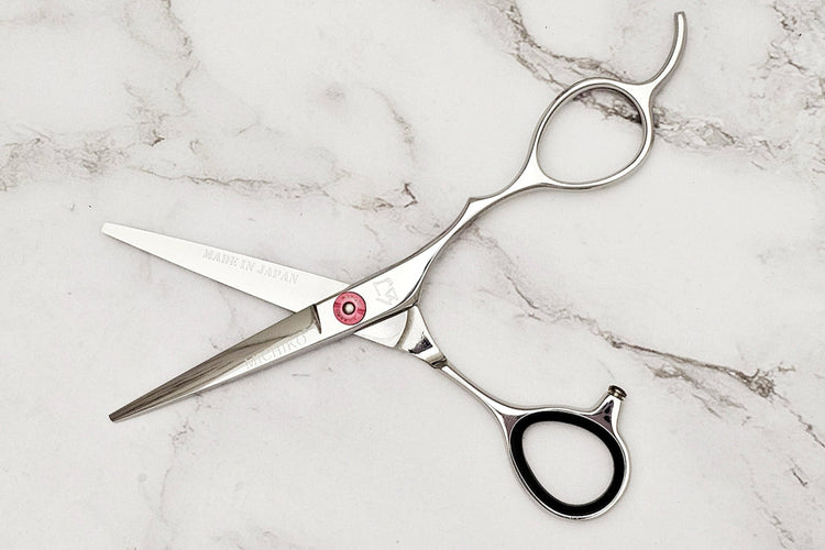 Hair cutting shears on a marble surface