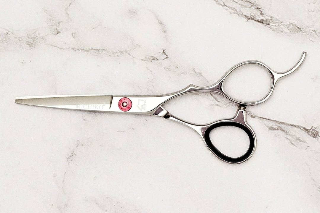 Hair cutting shears on a marble surface