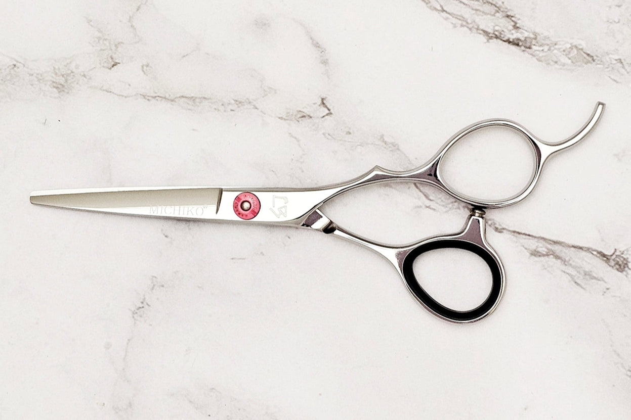 Hair cutting shears on a marble surface