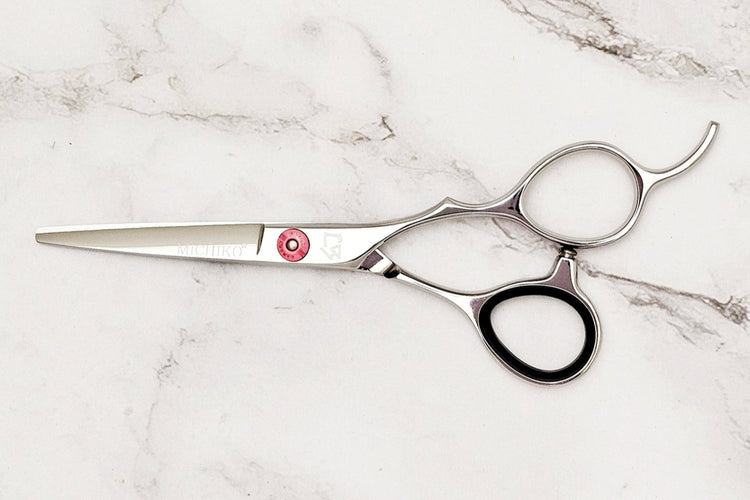 Hair cutting shears on a marble surface