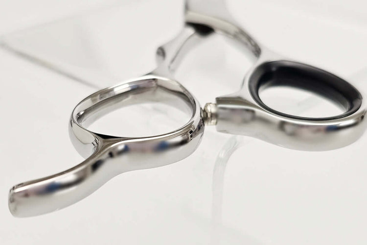 Close-up of hair scissors handle on a white background