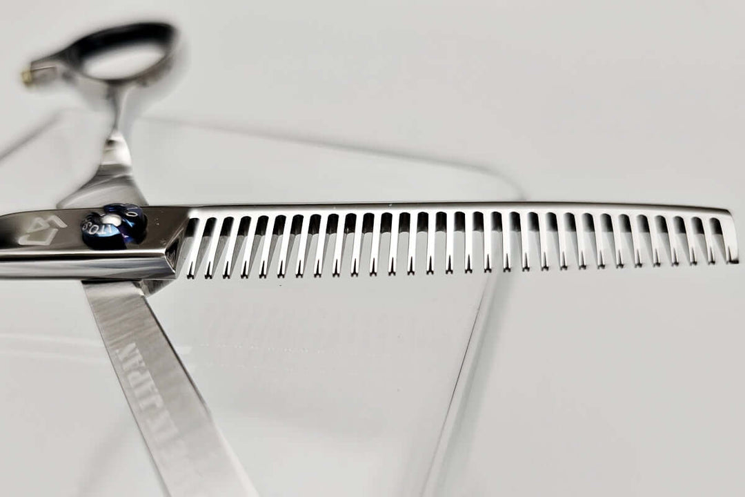 Close-up of hair thinning shears' teeth part on a white background