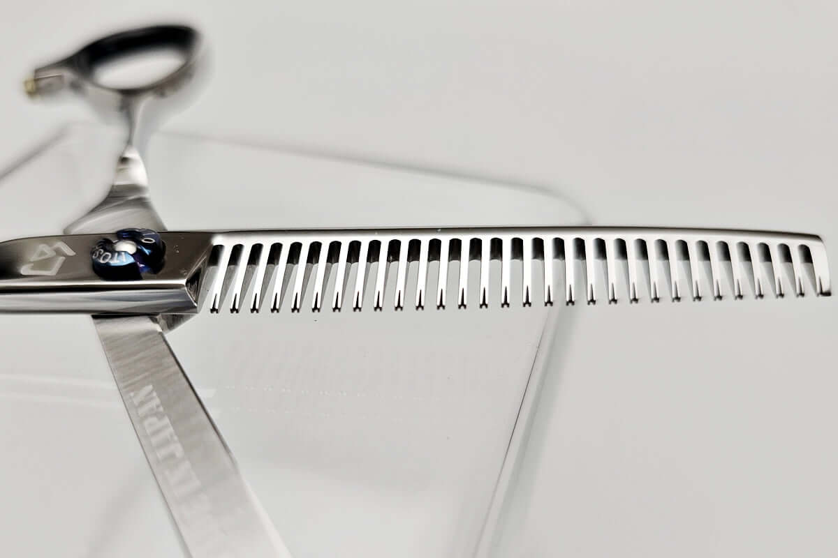 Close-up of hair thinning shears' teeth part on a white background
