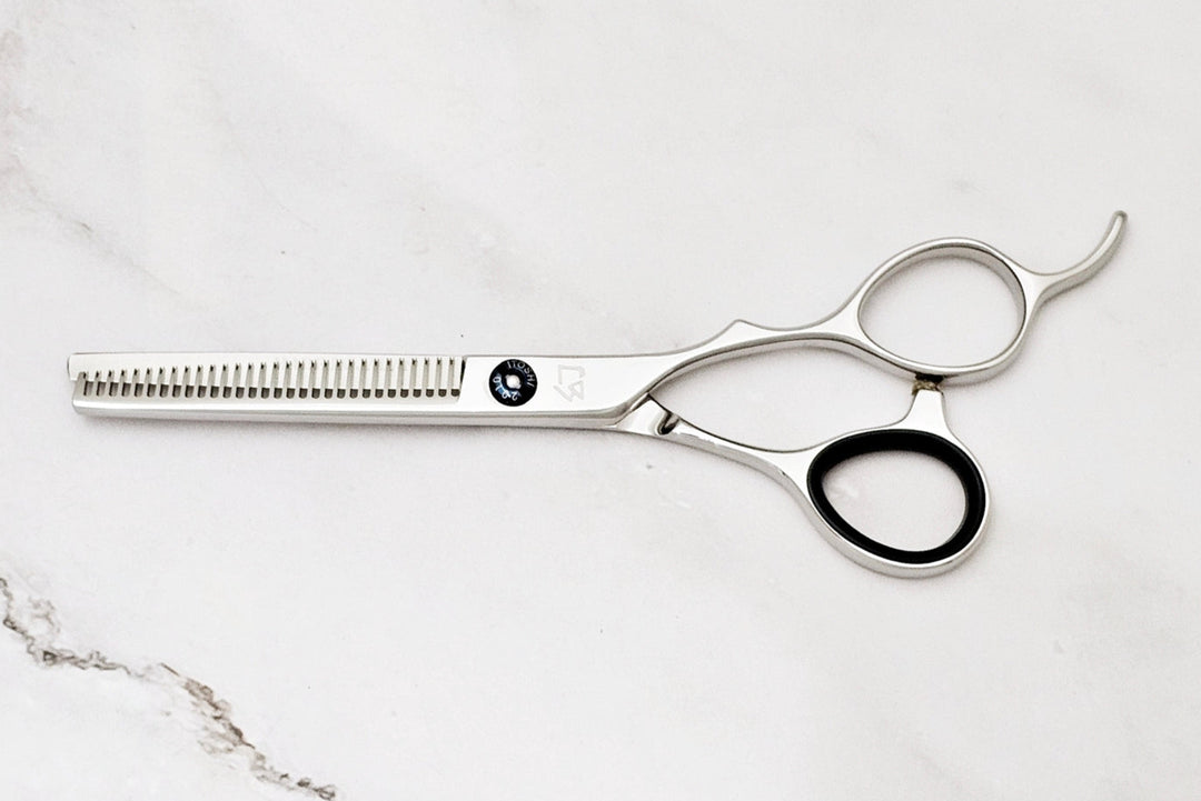 Hair cutting scissors on a marble surface