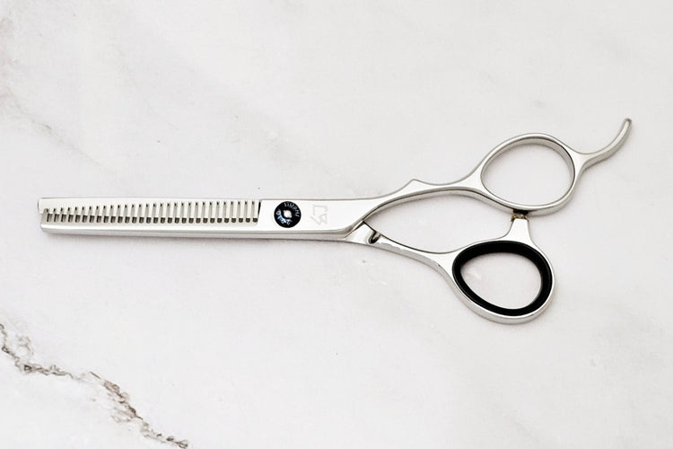 Hair cutting scissors on a marble surface