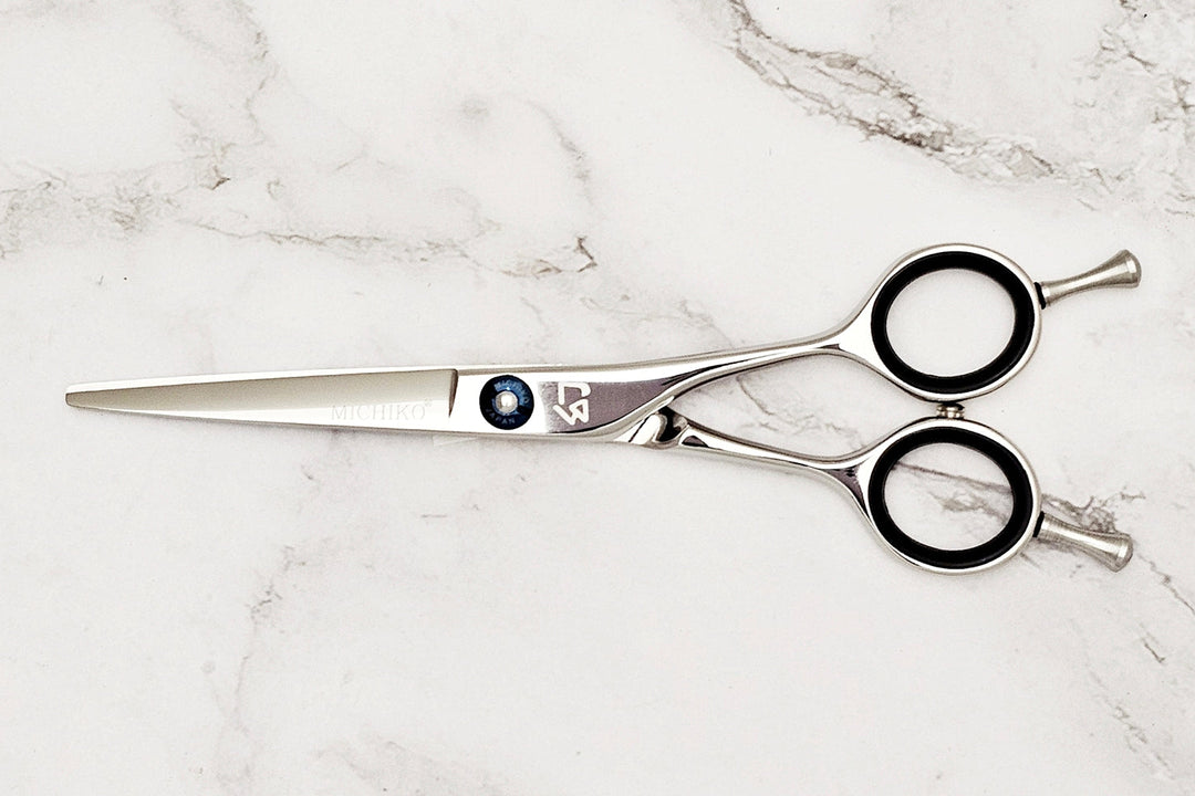 Hair cutting shears on a marble surface