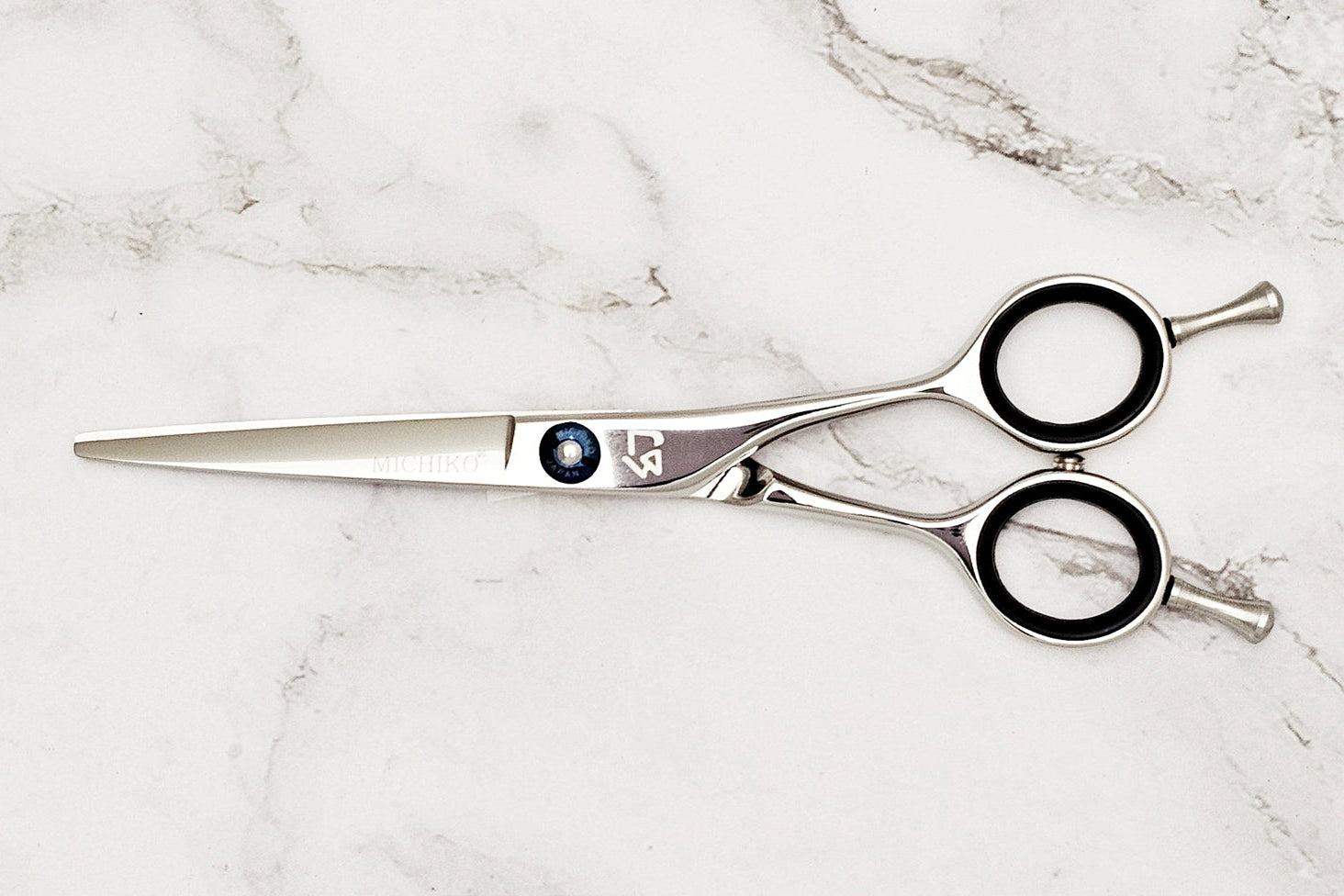 Hair cutting shears on a marble surface