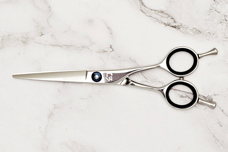 Hair cutting shears on a marble surface