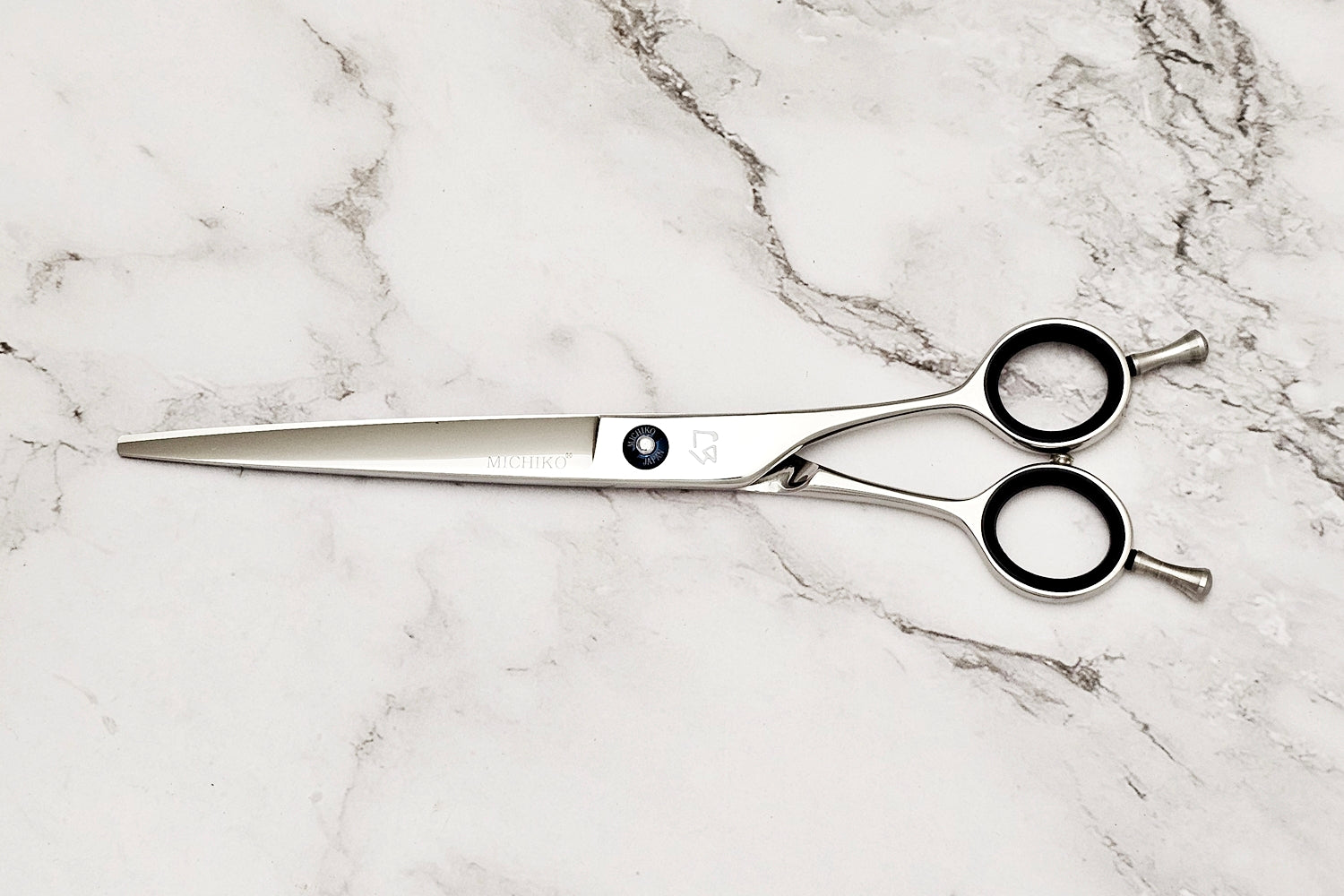 Hair Cutting Scissors on a Whte Marble Background