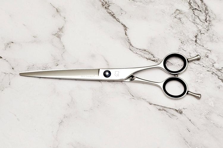 Hair Cutting Scissors on a Whte Marble Background