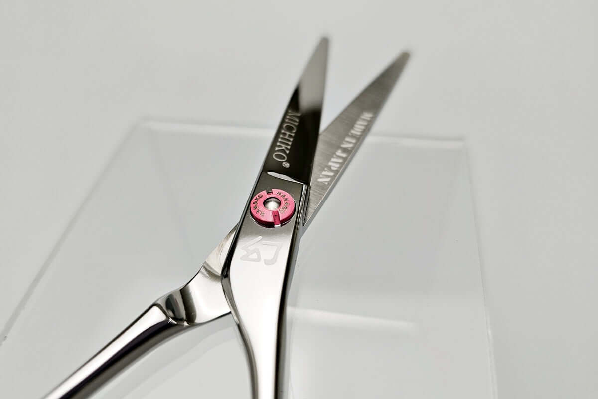 Hair cutting scissors with MICHIKO brand name on a white background