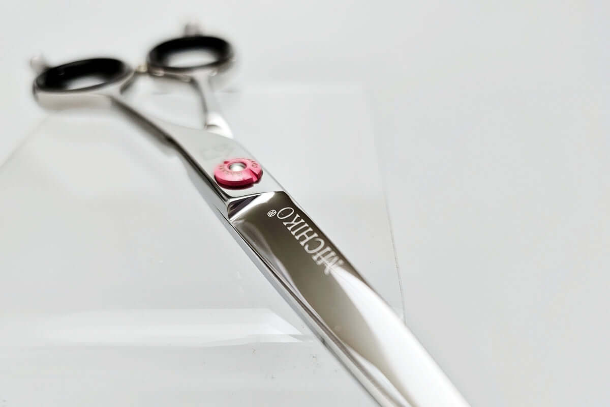 Hair cutting shears with 'MICHIKO' branding on a light gray background