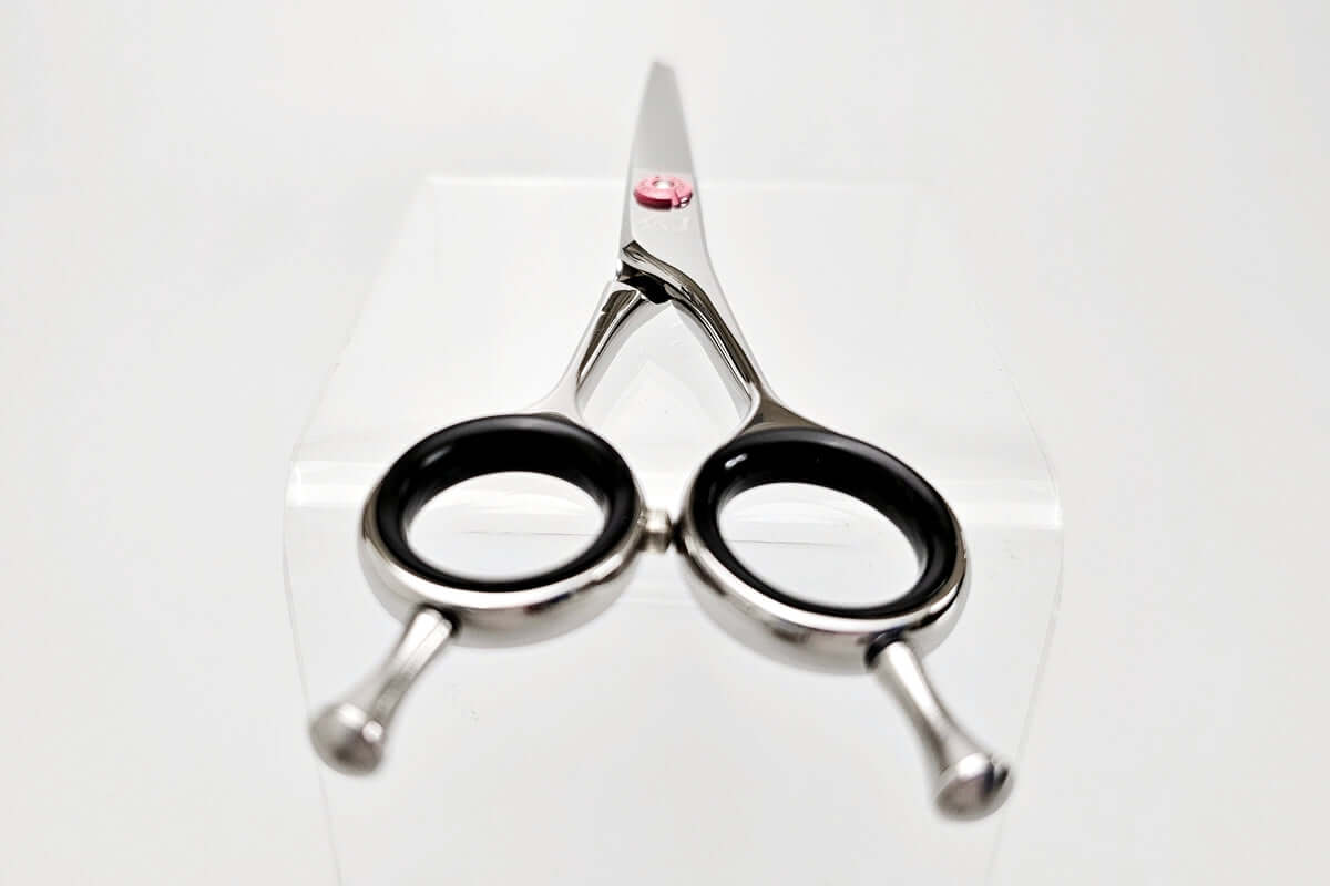 Hair cutting shears with black handles on a white background