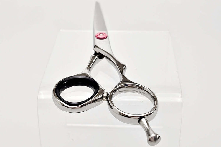 Hair scissors with black finger inserts on a white background